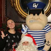 Alumni posing with Santa and Louie the Laker